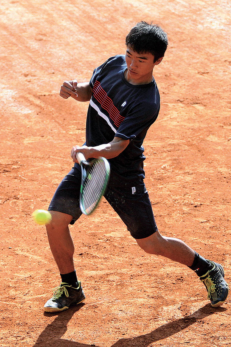 Taiyo Hirano of Japan returns to Naithaolin Calvin Golmei of India in boys singles quarter final match of Nepal ITF Juniors U-18 Circuit-I Tournament at the Satdobato Tennis Complex courts in Lalitpur on Thursday. Photo: THT
