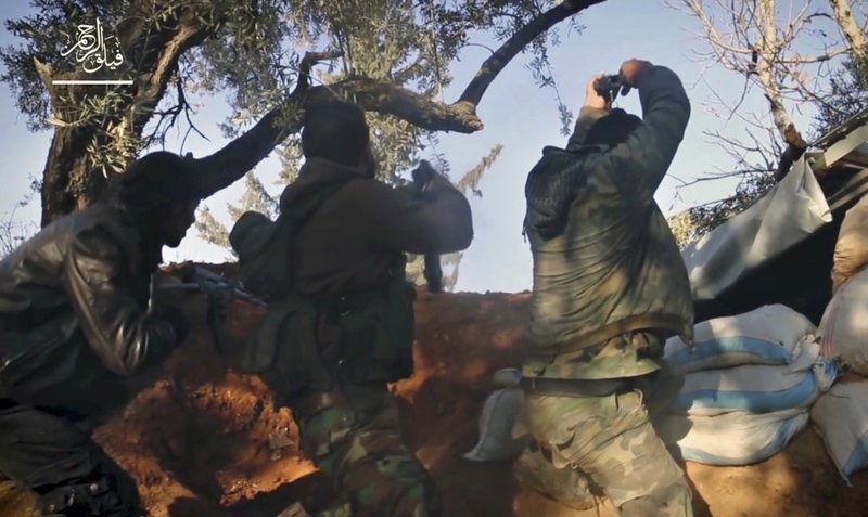 File - This frame grab from video provided , by the Syrian insurgent group Failaq al-Rahman, shows fighters with Failaq al-Rahman firing their weapons during clashes with government forces in the suburbs of the Syrian capital Damascus on Nov. 24, 2017. Photo: AP