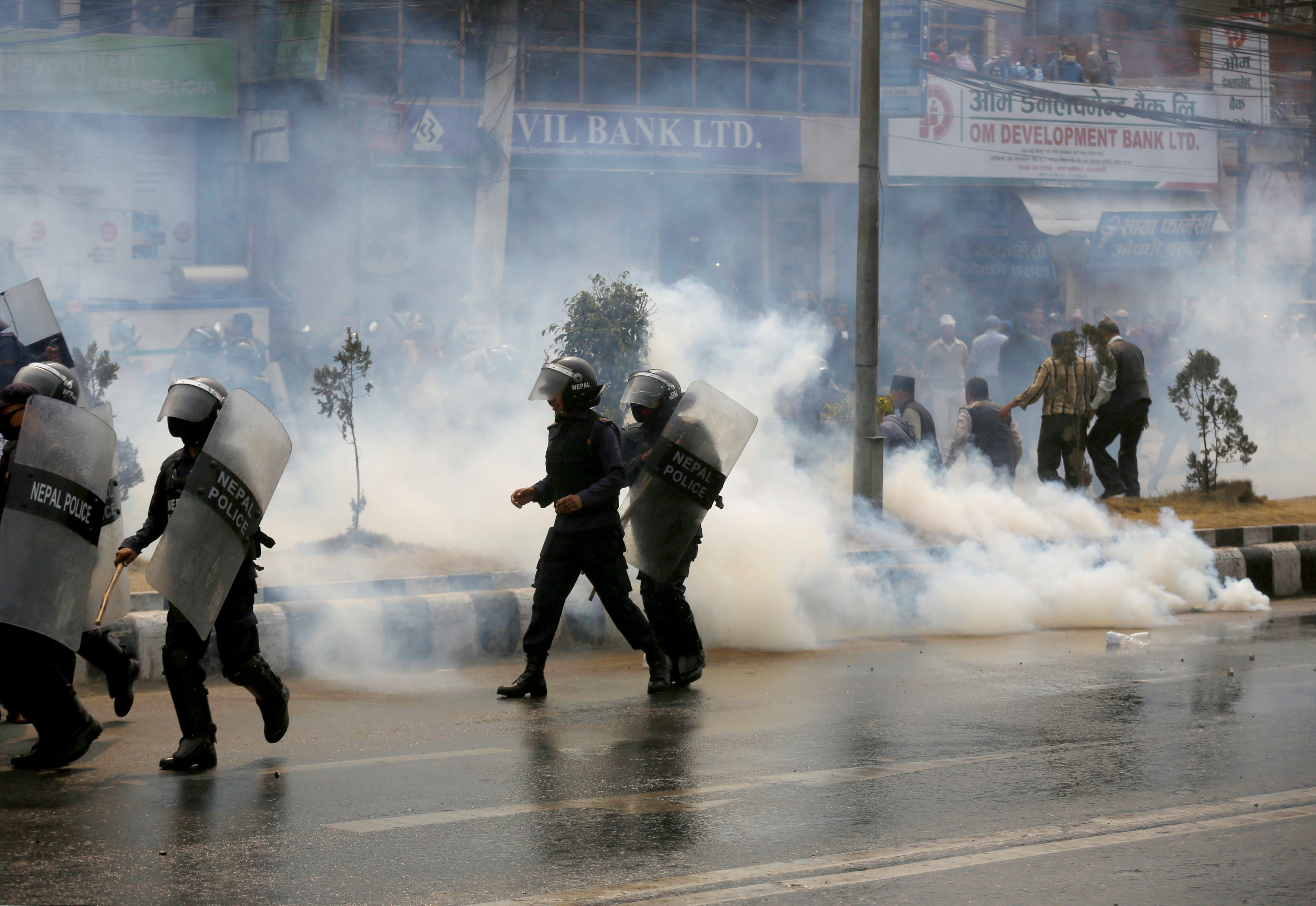 Smoke rise from a teargas shell fired by the police to disperse the crowd during the protest against the road expansion projects causing people in the affected areas to lose their houses and lands in Kathmandu, Nepal March 28, 2018. Photo: REUTERS