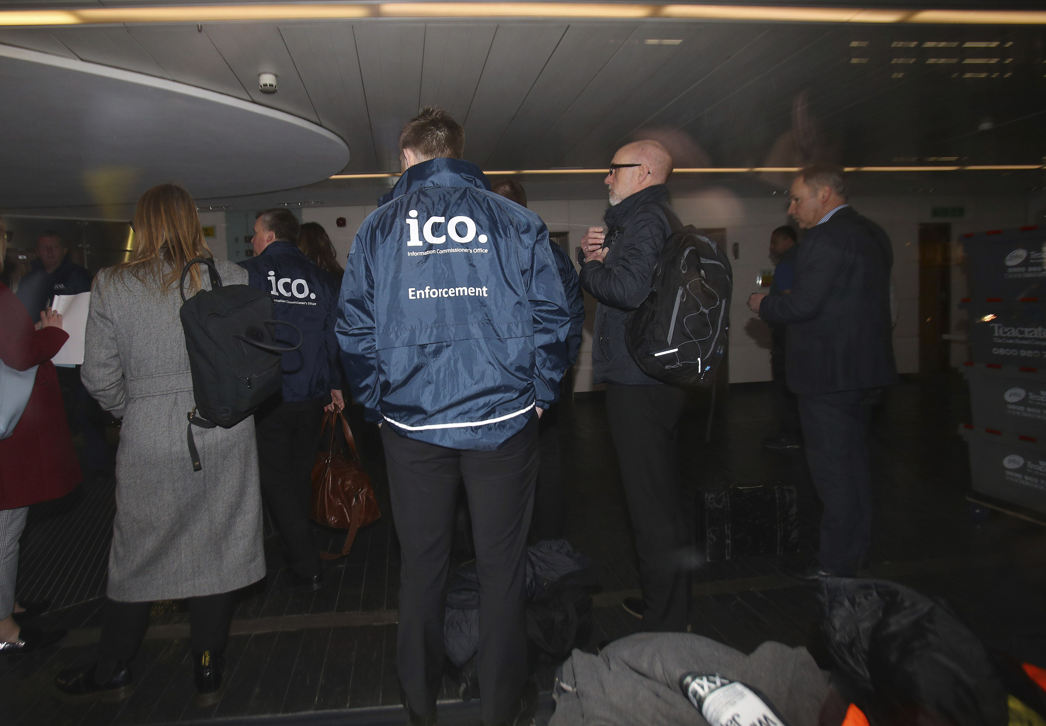 Enforcement officers working for Information Commissioner arrive at the offices of Cambridge Analytica in central London after a High Court judge granted a search warrant, Friday March 23, 2018.  The investigation into alleged misuse of personal information continues Friday to determine whether Cambridge Analytica improperly used data from some 50 million Facebook users to target voters with ads and political messages. (Yui Mok/PA via AP)