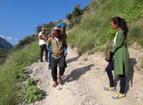 A man carrying a patient to a health facility for treatment, in Bajura, on Thursday, March 29, 2018. Photo: THT