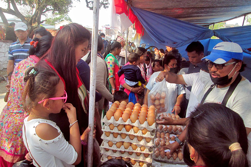 Customer buying egg during 3rd Damauli Festival in Tanahun district, on Sunday, March 11, 2018. Photo: Madan Wagle