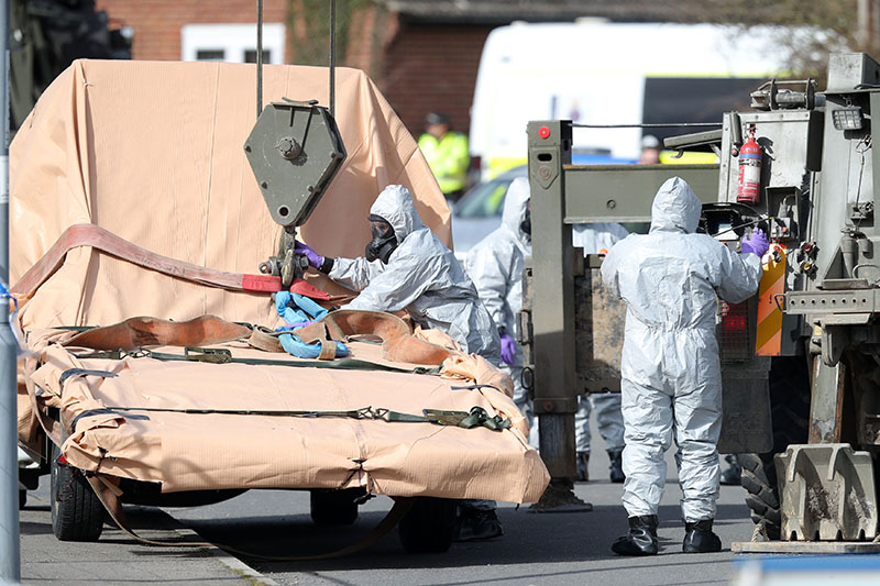 Soldiers wearing protective clothing prepare to lift a tow truck in Hyde Road, Gillingham, Dorset, England as the investigation into the suspected nerve agent attack on Russian double agent Sergei Skripal continues Wednesday March 14, 2018. Photo: Andrew Matthews/PA via AP