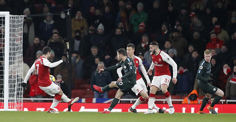 FILE: Manchester City's Bernardo Silva (centre), scores the opening goal during the English Premier League soccer match between Arsenal and Manchester City at the Emirates stadium in London, on Thursday, March 1, 2018. Photo: AP