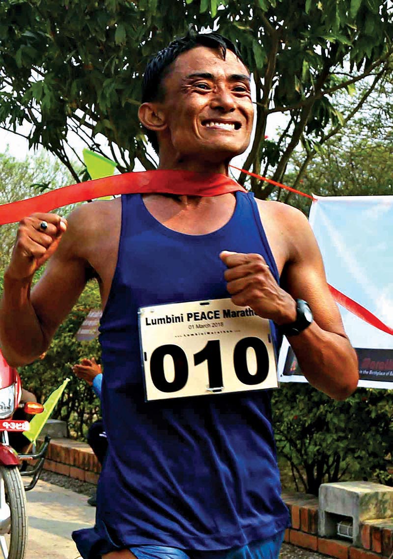 TAC athlete Homlal Shrestha crosses the finish line to win the Lumbini Peace Marathon in Bhairahawa on Thursday. Photo: THT