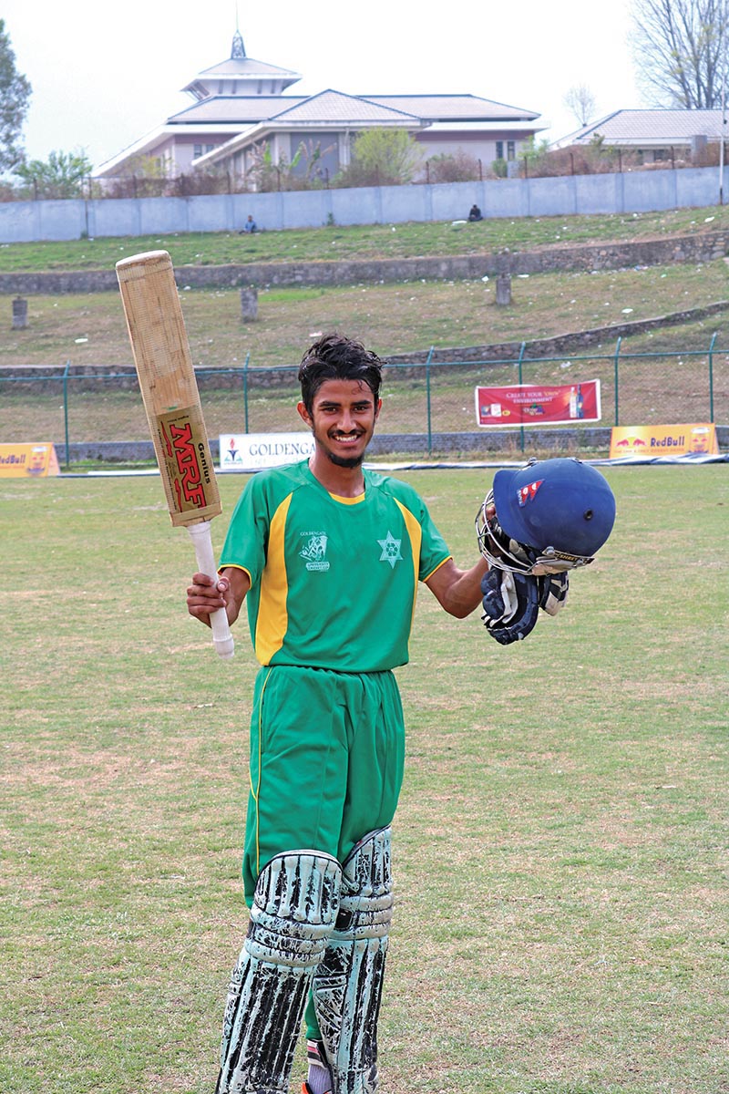 Ishan Pandey of Tribhuvan University celebrates his century against Caribbean College during the Golden Gate University Cricket Cup in Kathmandu on Tuesday. Photo: THT