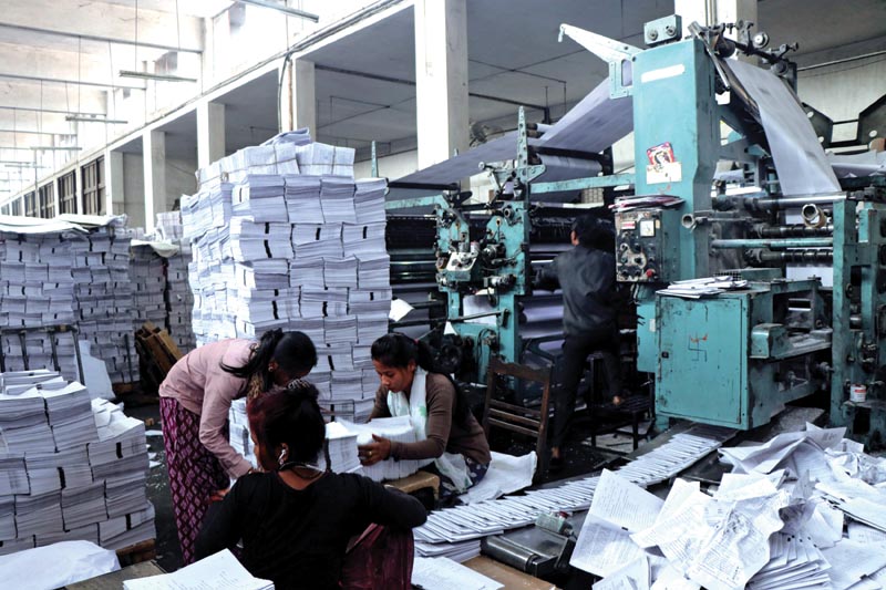 Workers arranging newly printed school textbooks at Janak Education Material Centre in Sano Thimi, Bhaktapur, on Thursday, March 29, 2018. Photo: THT