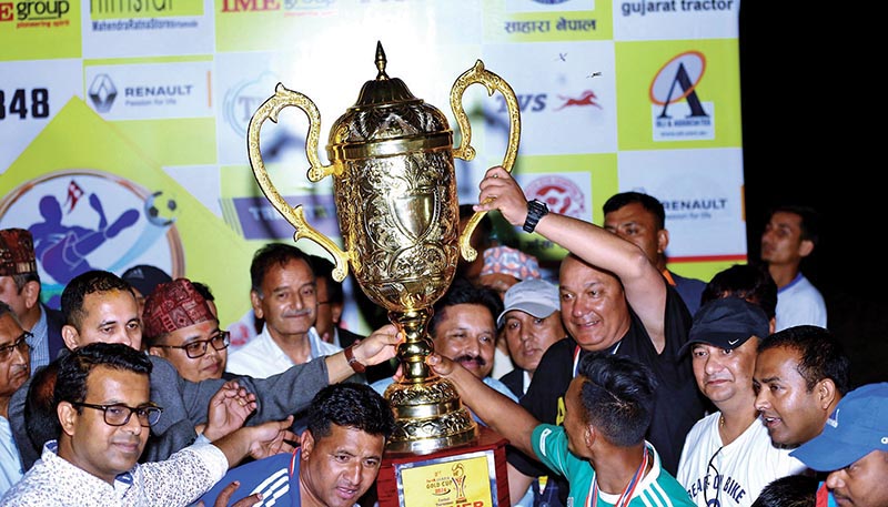 Tribhuvan Army Club team members celebrate with the trophy after winning the third Rumpum Jhapa Gold Cup at the Domalal Stadium in Birtamod on Monday. Photo: RSS