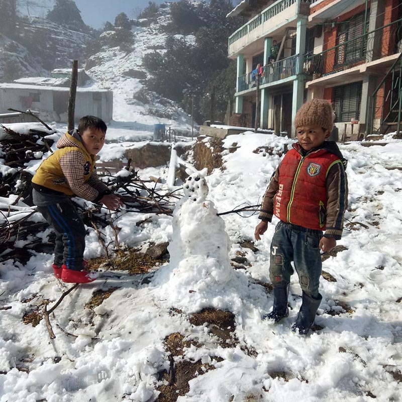 Children play with snow at Kuri of Kalinchowk, in Dolakha, on Monday, March 12, 2018. Photo: THT