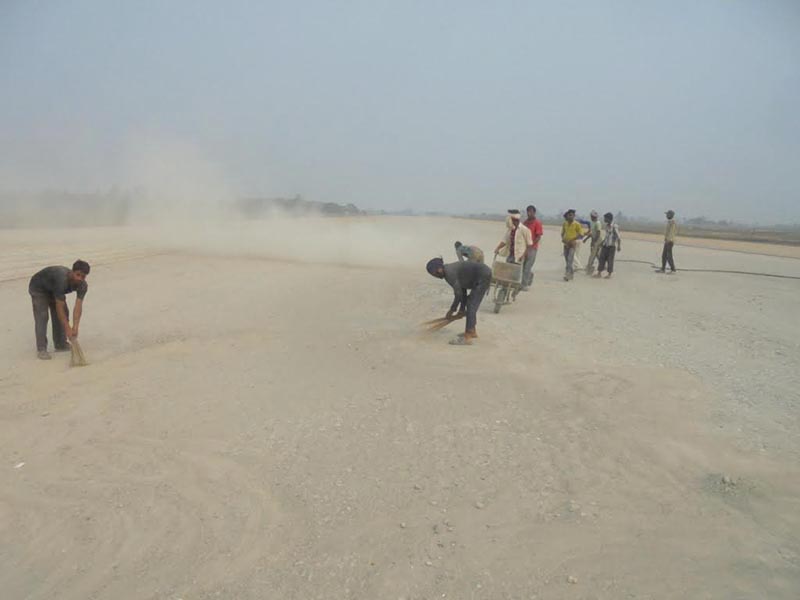 Workers clearing dust prior to blacktopping the runway in Rajbiraj Airport, on Sunday, March 18, 2018. Photo: THT