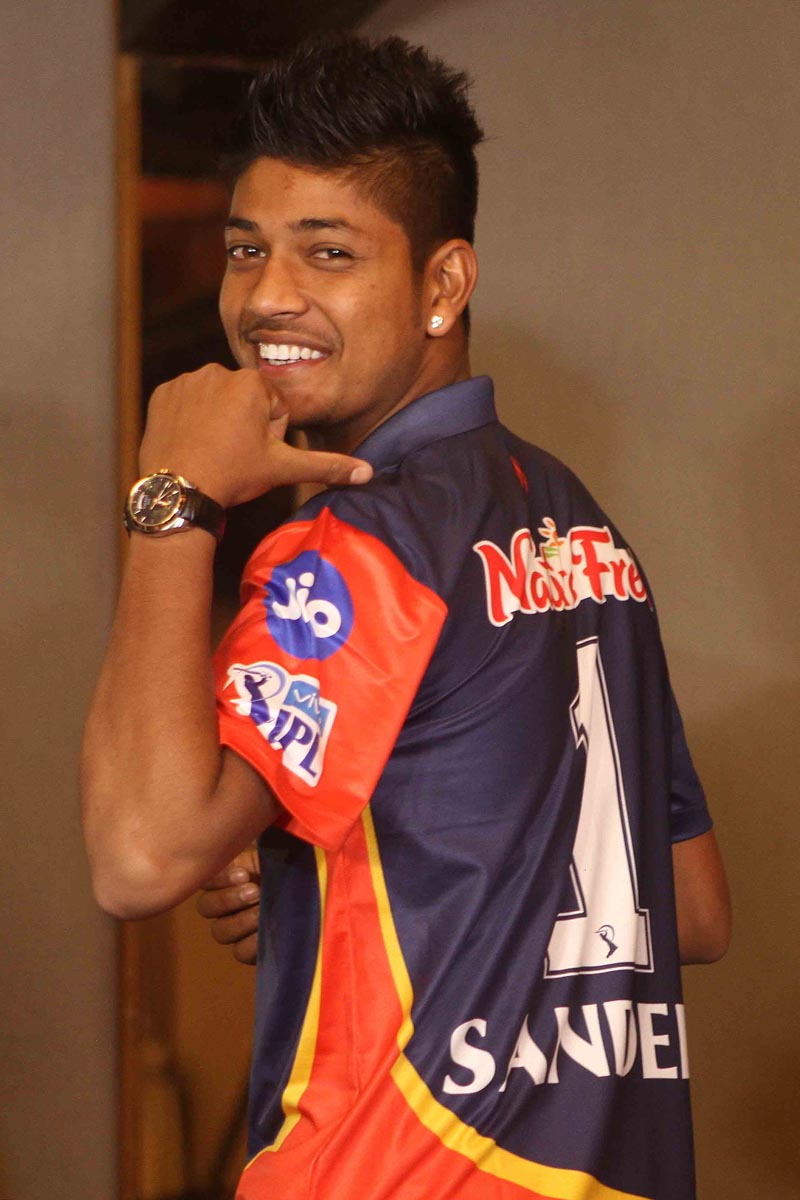 Nepalu0092s Sandeep Lamichhane gestures as he dons IPL franchise Delhi Daredevils jersey.