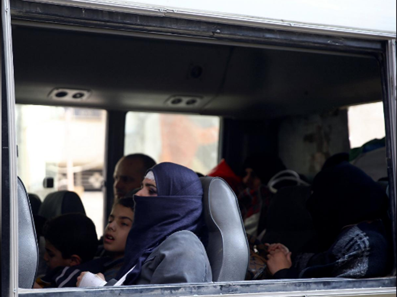 Civilians are seen in a bus during evacuation from the besieged town of Douma, Eastern Ghouta, in Damascus, Syria on March 13, 2018. Photo: Reuters 