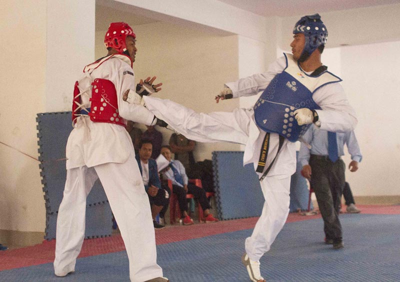 Sakshyam Karki (right) fights against Bhupendra Shrestha in men's below 80kg final bout during their internal selection match as part of preparation for Asian Games in Indonesia at National Taekwondo Training Center, Satdobato in Lalitpur on Friday, March 23, 2018. Photo: THT