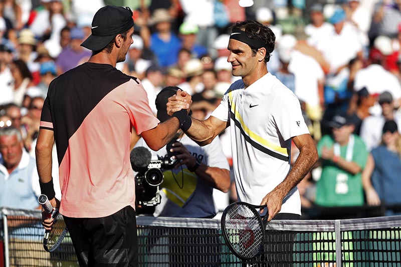 Thanasi Kokkinakis of Australia (left) shakes hands with Roger Federer of Switzerland (right) after their match on day five of the Miami Open at Tennis Center at Crandon Park, in Key Biscayne, Florida, USA, on March 24, 2018. Photo: Geoff Burke-USA TODAY Sports via Reuters
