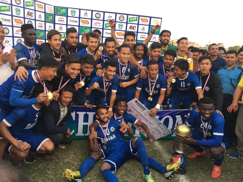 Ruslan Three Star Club team members celebrate with the trophy after winning the 20th Tilottama Gold Cup at the ANFA Technical Centre in Butwal on Saturday, March 17, 2018. Photo: THT