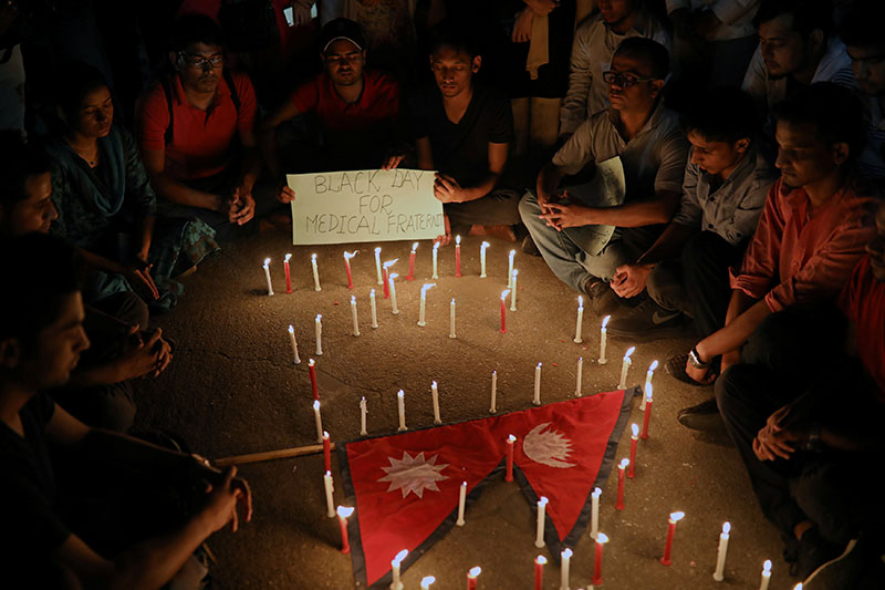 People including Nepali students of University of Dhaka light candles in memory of the victims of the US-Bangla aircraft crash in Nepal, in Dhaka, Bangladesh March 14, 2018. Photo: Reuters