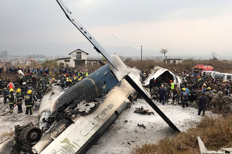 Wreckage of an airplane is pictured as rescue workers operate at Kathmandu airport, Nepal March 12, 2018. Photo: Reuters