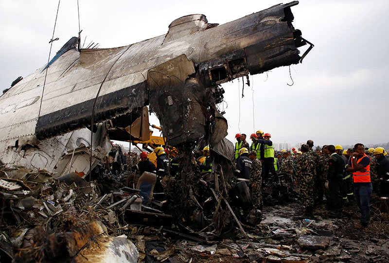 Rescue workers operate at the wreckage of the US-Bangla airplane after it crashed at Tribhuvan International Airport, in Kathmandu, Nepal, on Monday, March 12, 2018. Photo: Reuters