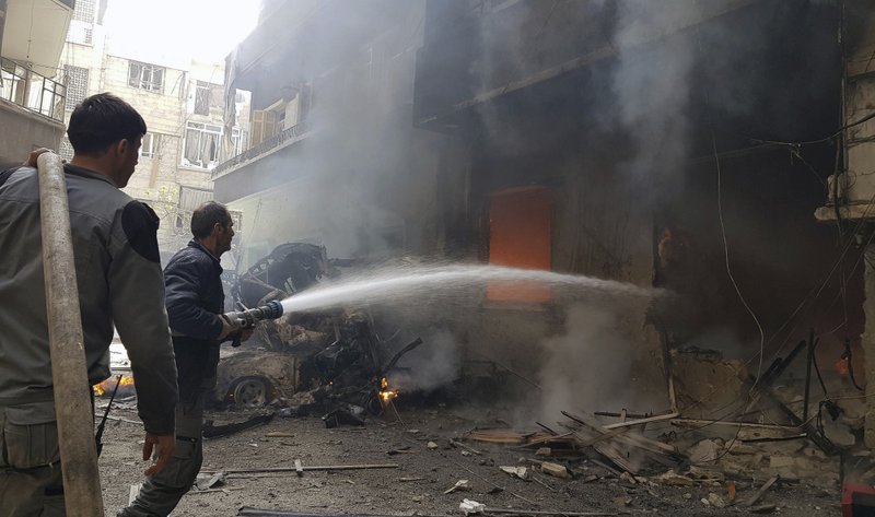 File- Civil Defense workers putting out a fire following airstrikes and shelling in Douma, in the eastern Ghouta region near Damascus, Syria, on Tuesday, March. 20, 2018. Photo: AP