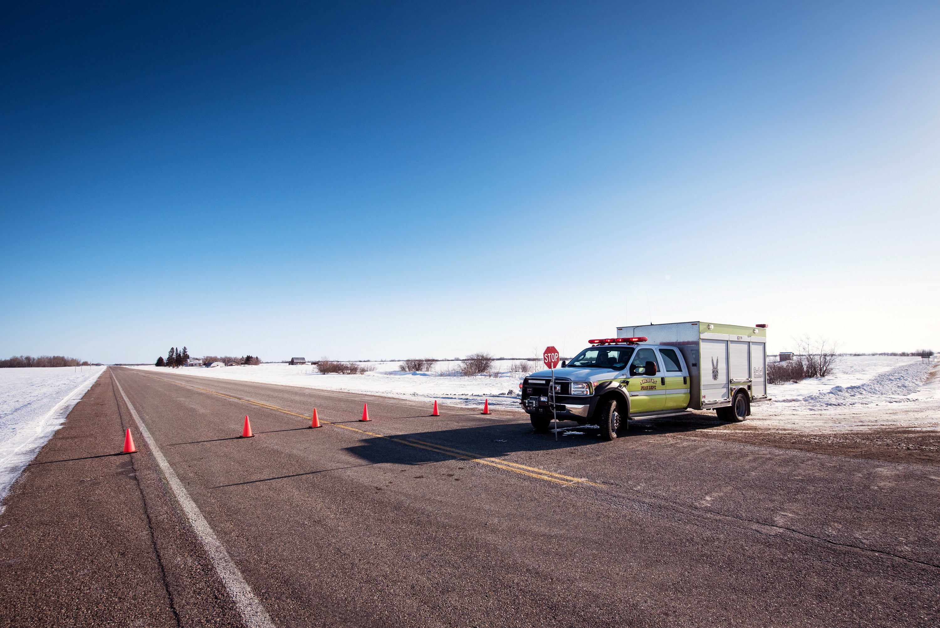 An emergency vehicle blocks the road to traffic the day after a bus carrying the Humboldt Broncos junior hockey team collided with a semi-trailer near Tisdale, Saskatchewan, Canada April 7, 2018.  REUTERS/Matt Smith