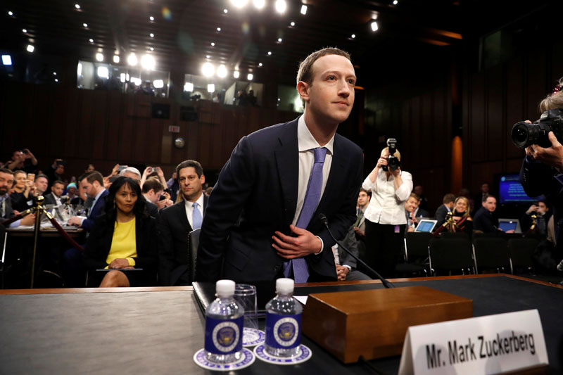 FILE PHOTO: Facebook CEO Mark Zuckerberg arrives to testify before a Senate Judiciary and Commerce Committees joint hearing regarding the companyu2019s use and protection of user data, on Capitol Hill in Washington, DC, U.S., April 10, 2018.  REUTERS/Aaron P. Bernstein/File Photo