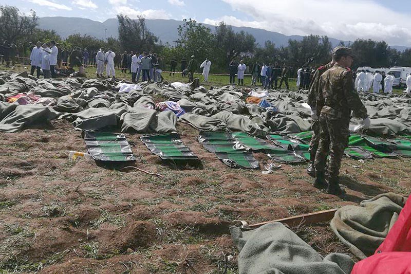 Bodies are gathered near scene of a fatal military plane crash at Boufarik military air base near the Algerian capital, Algiers, on Wednesday, April 11, 2018. An Algerian military plane carrying soldiers and their families crashed soon after takeoff Wednesday into a field in northern Algeria, killing more than 250 people in what appeared to be the North African nation's worst-ever plane crash. Photo: Ennahar TV via AP