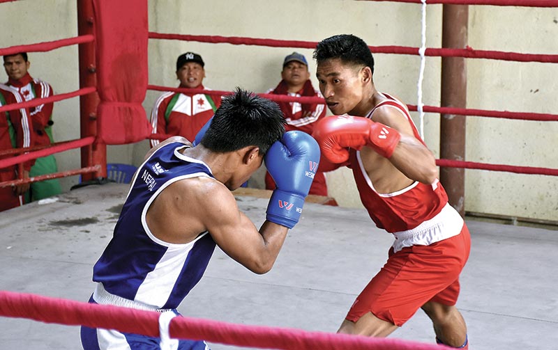 Boxers Puran Rai of Nepal APF Club (left) and Bimal Rokka of TAC fight during the selection tournament for the 18th Asian Games in Lalitpur on Thursday. Photo: Naresh Shrestha/ THT