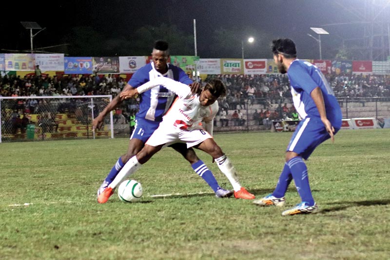 Aditya Chaudhary of APF vies for the ball with CMG Club Sankata players during their Birat Gold Cup match in Biratnagar on Tuesday. Photo: THT