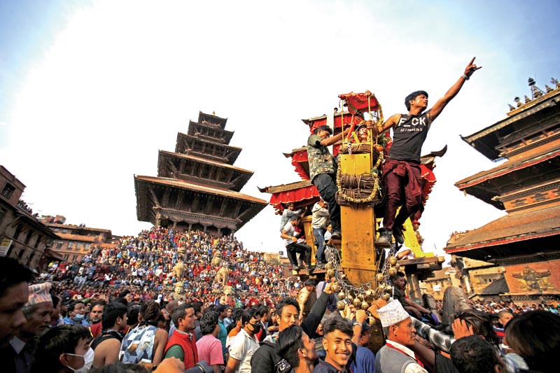 Nepalese devotees pull a chariot of Deity Bhairab during celebrations of the traditional Biska festival in Bhaktapur, Nepal on Tuesday, April 10, 2018. During the festival devotees of eastern and western part of town pull chariots competing in a tug of war to commemorate the start of the Nepalese New Year. Photo: THT