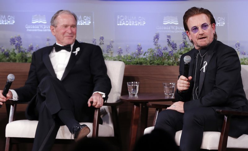 Former President George W. Bush, left, and U2 musician Bono participate in a Q&amp;A session during a gala for the Forum on Leadership at the George W. Bush Institute, on Thursday, April 19, 2018, in Dallas. Photo: APn