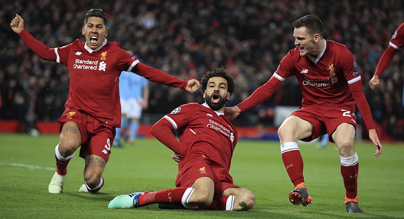 Liverpool's Mohamed Salah (centre), celebrates with teammates after scoring his side's first goal of the game during the Champions League quarter final, first leg soccer match between Liverpool and Manchester City at Anfield, Liverpool, England, on Wednesday, April 4, 2018. Photo: Peter Byrne/PA via AP