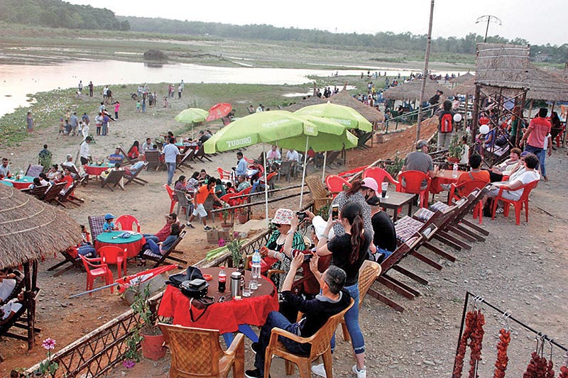 Tourists relaxing on the banks of the Rapti River in Sauraha, Chitwan, on Monday, April 16, 2018. Photo: RSS