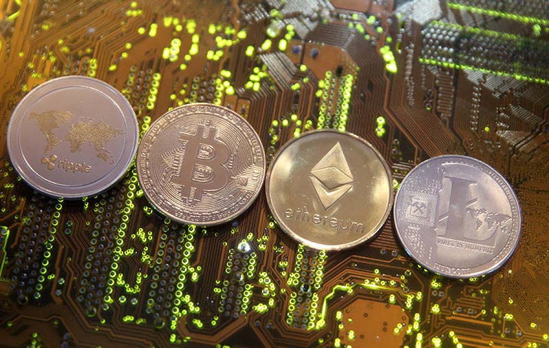 Representations of the Ripple, Bitcoin, Etherum and Litecoin virtual currencies are seen on a PC motherboard in this illustration picture, February 13, 2018. Photo: Reuters/ File