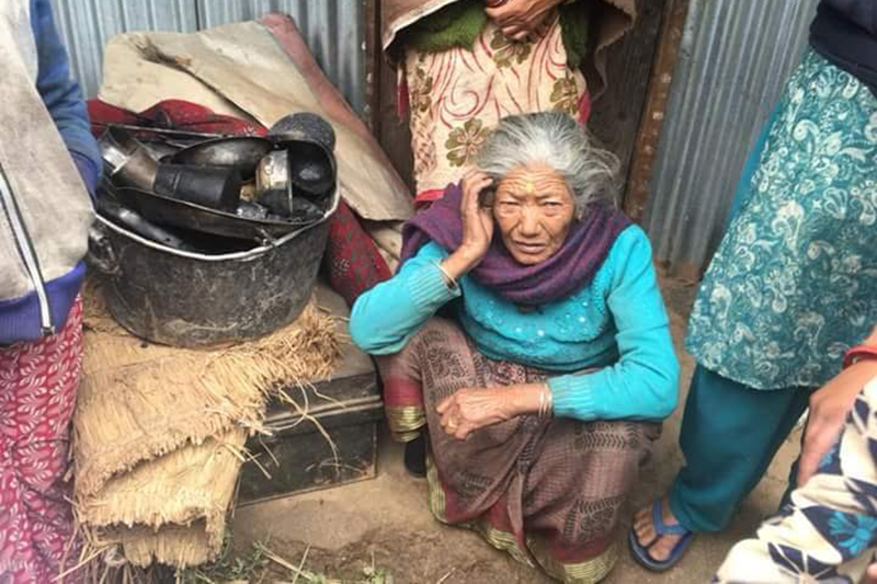 A woman sitting under the open sky after her house was gutted, in Dolakha, on Friday, April 6, 2018. Photo: THT