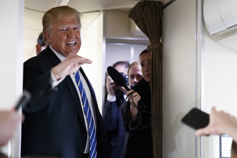File - President Donald Trump talks with reporters aboard Air Force One on a flight to Andrews Air Force Base, Md., on Thursday, April 5, 2018. Photo: AP