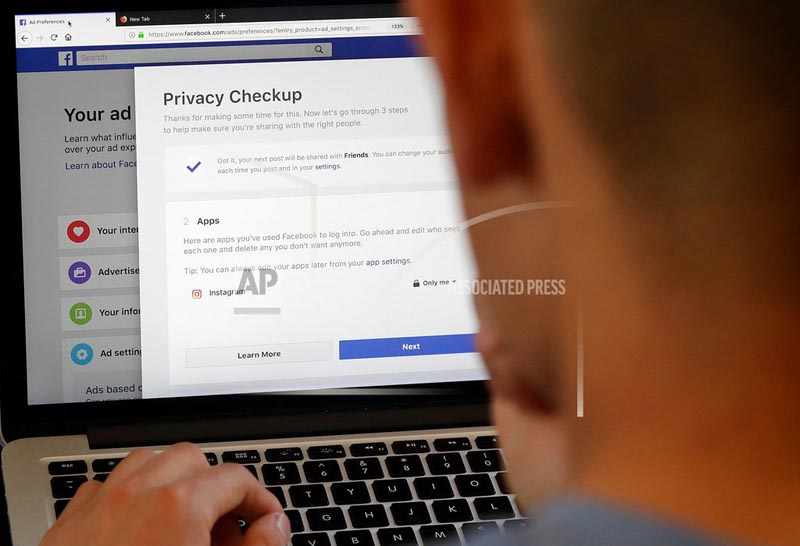 FILE - In this March 26, 2018, file photo, a man poses for photos in front of a computer showing Facebook ad preferences pages in San Francisco. Photo: AP