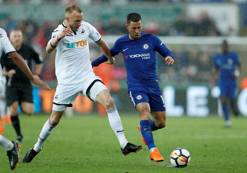 Chelsea's Eden Hazard in action with Swansea City's Mike van der Hoorn during Swansea City vs Chelsea, in the Premier League, at Liberty Stadium, Swansea, Britain, on April28, 2018. Photo: Reuters