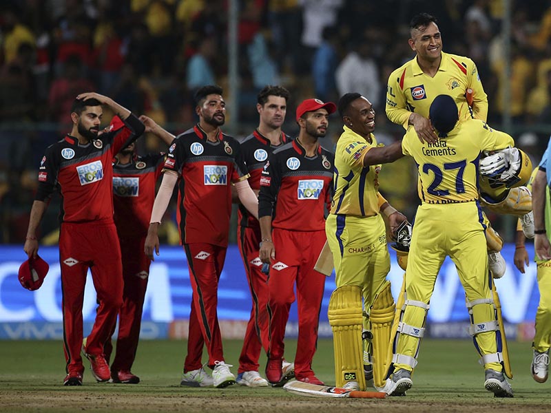 Chennai Super Kings' Harbhajan Singh, right, lifts captain Mahendra Singh Dhoni to celebrate their win in the VIVO IPL Twenty20 cricket match against Royal Challengers Bangalore in Bangalore, India, Wednesday, April 25, 2018. Chennai Super Kings won the match by five wickets. (AP Photo/Aijaz Rahi)