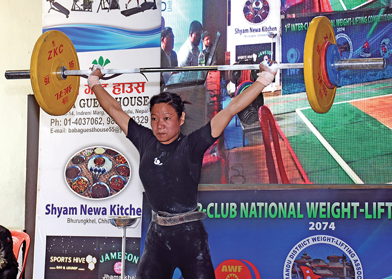 Nepal Police Club's Sangita Rai lifts weight during the first Inter-club National Weightlifiting Tournament in Laitapur on Wednesday. Photo: THT