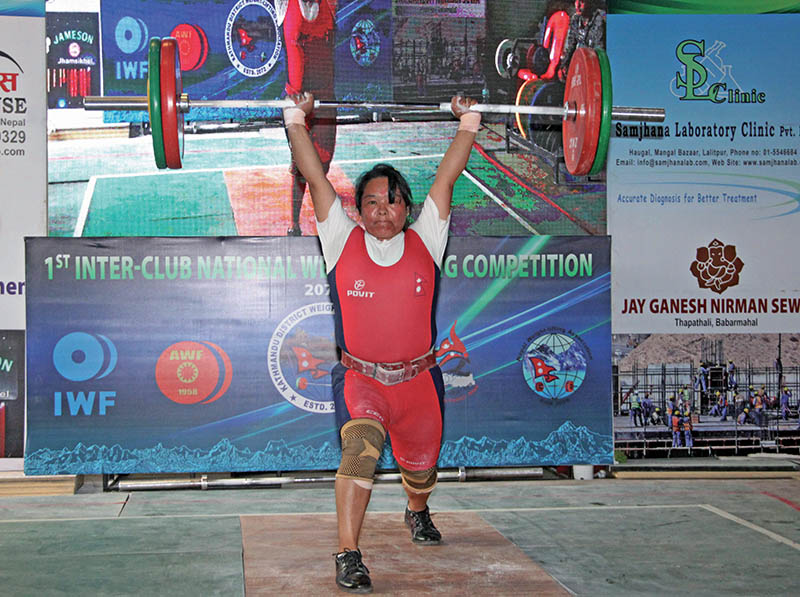 Tara Devi Pun of Nepal Police Club lifts weight during the first Inter-club Weightlifting Championship in Lalitpur on Thursday. Photo: THT
