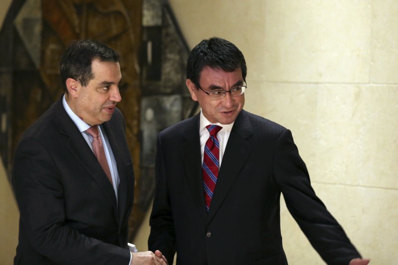 Jordanu2019s Planning Minister Imad Fakhoury, left, shakes hands with Japanu2019s Foreign Minister Taro Kono before a meeting on the u201cCorridor for Peace and Prosperity,u201d at Dead Sea, Jordan, on Sunday, April 29, 2018. Photo: AP