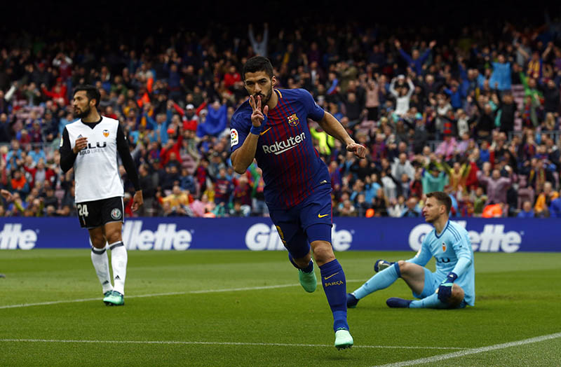 FC Barcelona's Luis Suarez celebrates after scoring during the Spanish La Liga soccer match between FC Barcelona and Valencia at the Camp Nou stadium in Barcelona, Spain, on Saturday, April 14, 2018. Photo: AP