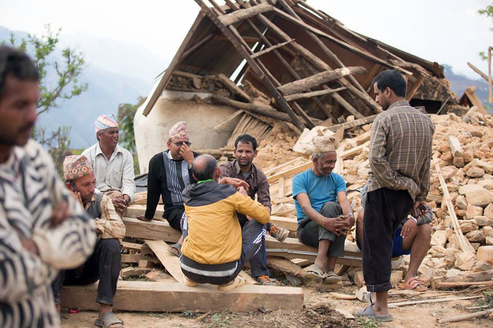 FILE PHOTO: Locals idle in front a house ravaged by April-2015 Earthquake in Lamjung District. Photo: Ramji Rana