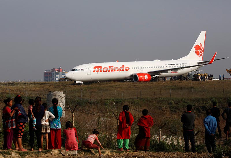 People look at an aircraft belonging to Malindo Air that slid off the runway during take-off last night at Tribhuvan International Airport in Kathmandu, on Thursday, April 20, 2018. Photo: Navesh Chitrakar