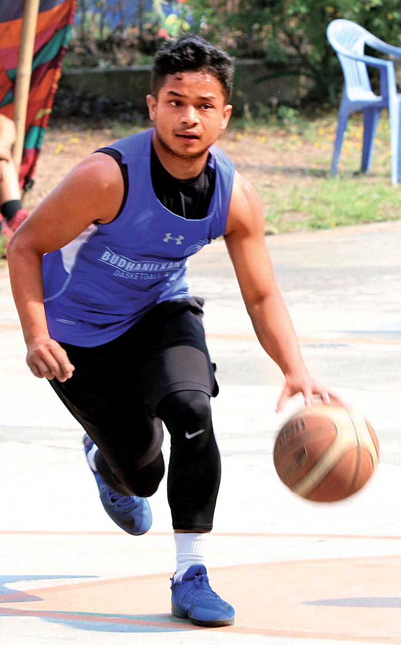 Biraj Rana of Budhanilkantha dribbles the ball against Ballers during their first Manmohan Memorial Open Basketball Tournament match in Kathmandu on Wednesday. Photo: THT