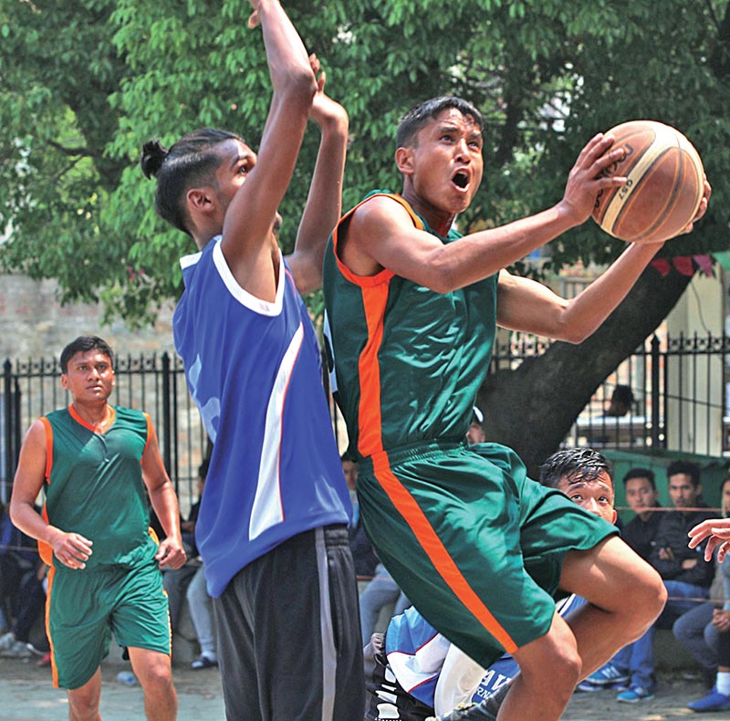 Krishna Kumar Shrestha of TAC 'B' jumps for a basket under pressure from Xavier International players during their first Manmohan Memorial Open basketball Tournament match in Kathmnadu on Monday. Photo THT