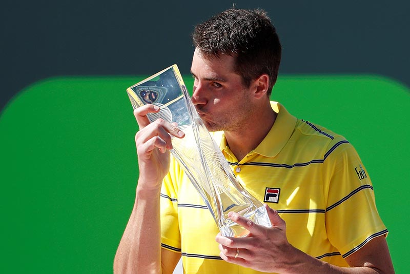 John Isner of the United States kisses the Butch Buchholz championship trophy after his match against Alexander Zverev of Germany (not pictured) in the men's singles final of the Miami Open at Tennis Center at Crandon Park, in Key Biscayne, Florida, USA, on April 1, 2018. Photo: Geoff Burke-USA TODAY Sports via Reuters