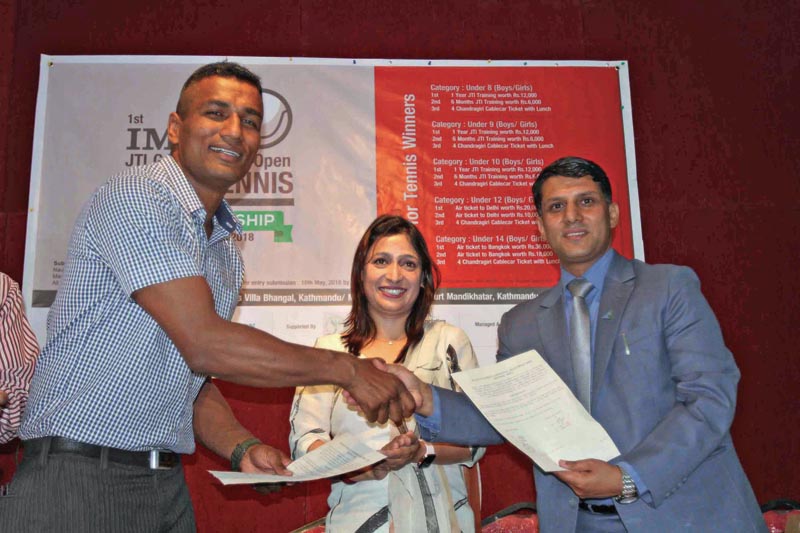 Boxer Manohar Basnet (left) and Raju Poudel Member of IME Foundation exchange MoU while Anjali Aryal Dhakal Member Secretary of IME Foundation look on during MoU signing ceremony in Kathmandu on Friday, April 27, 2018. Photo: THT