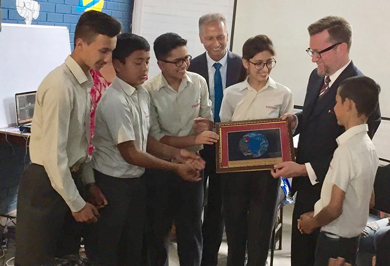 Public Affairs Officer at the US Embassy Tristram Perry receiving an artwork by a student, in Kathmandu, on Saturday. Photo: THT
