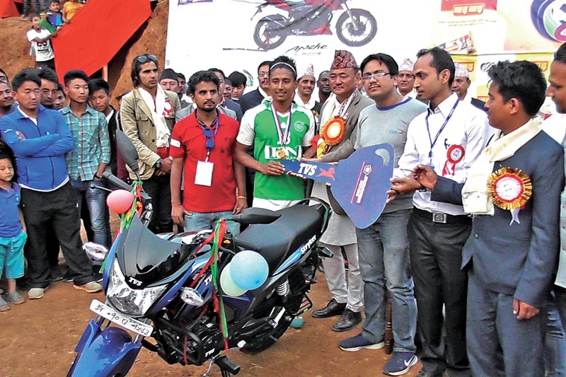 Birtamod United's Nawayug Shrestha receives a TVS motorbike after being named the best player of the Panchthar Gold Cup in Panchthar on Sunday. Photo: THT